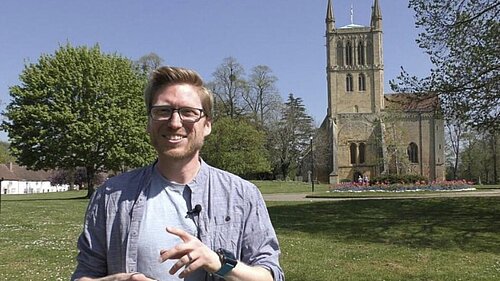 Dan Boatright-Greene standing in front of Pershore Abbey