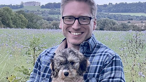 Dan Boatright-Greene holding a small dog